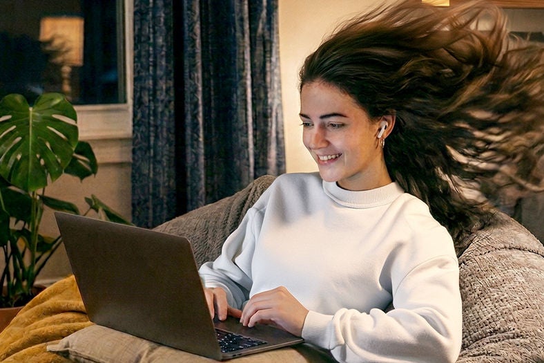 Girl on laptop surfing the Internet using Optimum Smart Wi-Fi