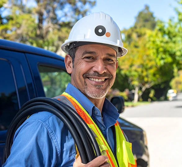 Optimum technician installing Fiber Internet equipment at customer home