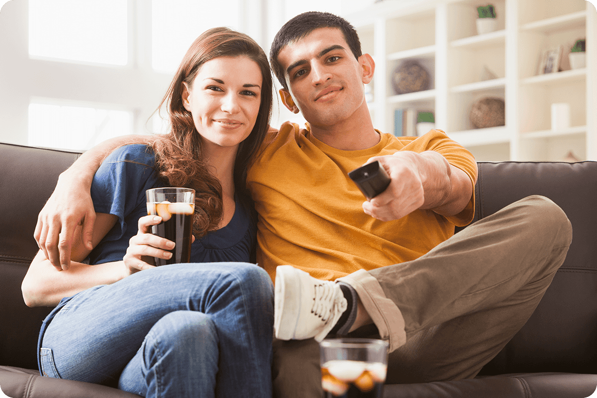 Man & Woman watching TV on a Samsung The Frame Smart TV