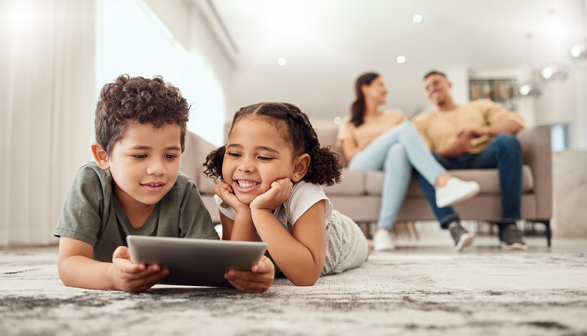 Young children enjoying a kids’ tablet with strong home Wi-Fi connection, showing how the best tablets for kids support fun and learning.